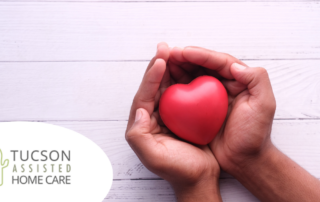 Hands holding a heart shape represent the care and support that those caring for seniors at home need.