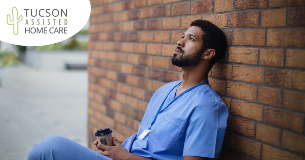 An exhausted professional caregiver takes a break outside.
