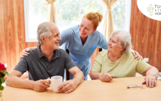 A good caregiving environment can benefit both caregiver and clients, as shown here by this caregiver and her 2 clients.