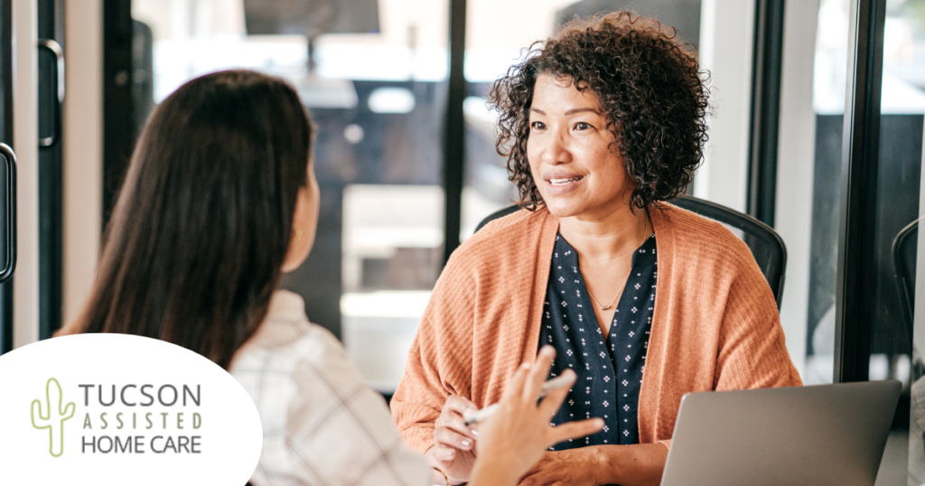 A woman interviews another woman for a caregiver job position.