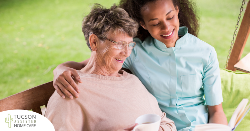 Professional caregivers like this one who is reading a book with a senior client can help them stay mentally active and engaged.